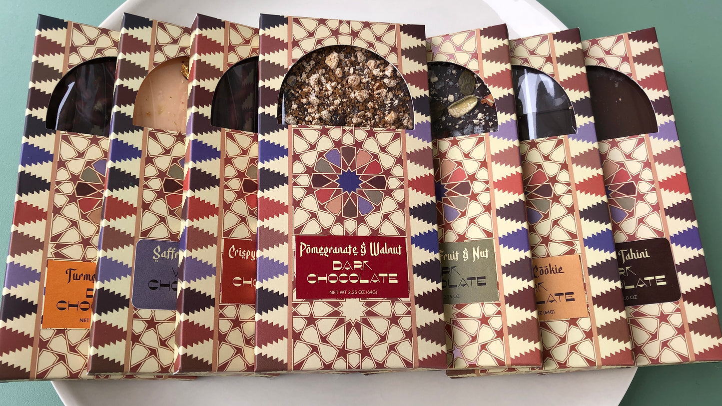 A variety of chocolate bars with different flavors, each packaged in individual boxes with decorative patterns.