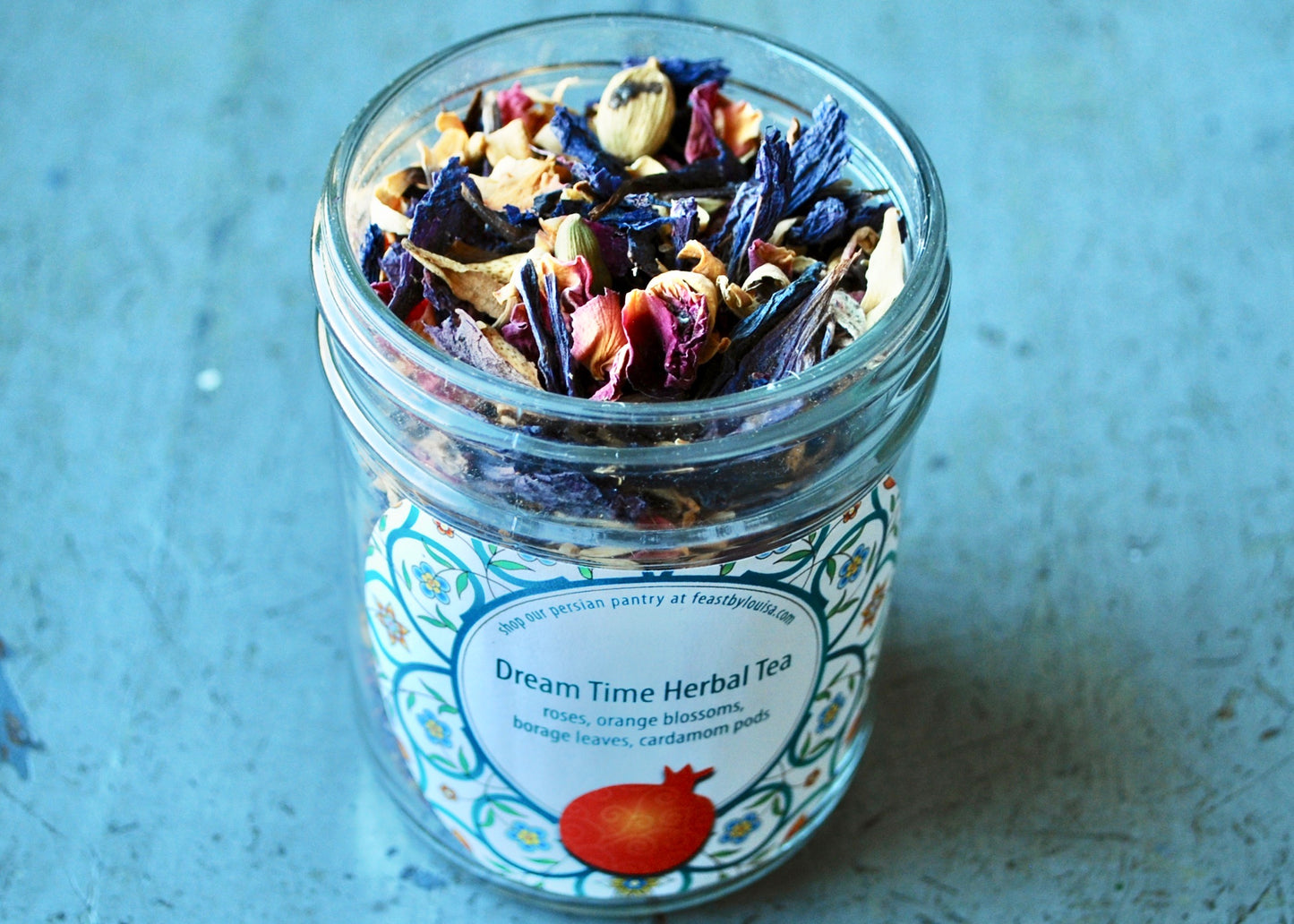 Dream Time Herbal Tea featuring roses, orange blossoms, borage leaves and cardamom pods in a jar