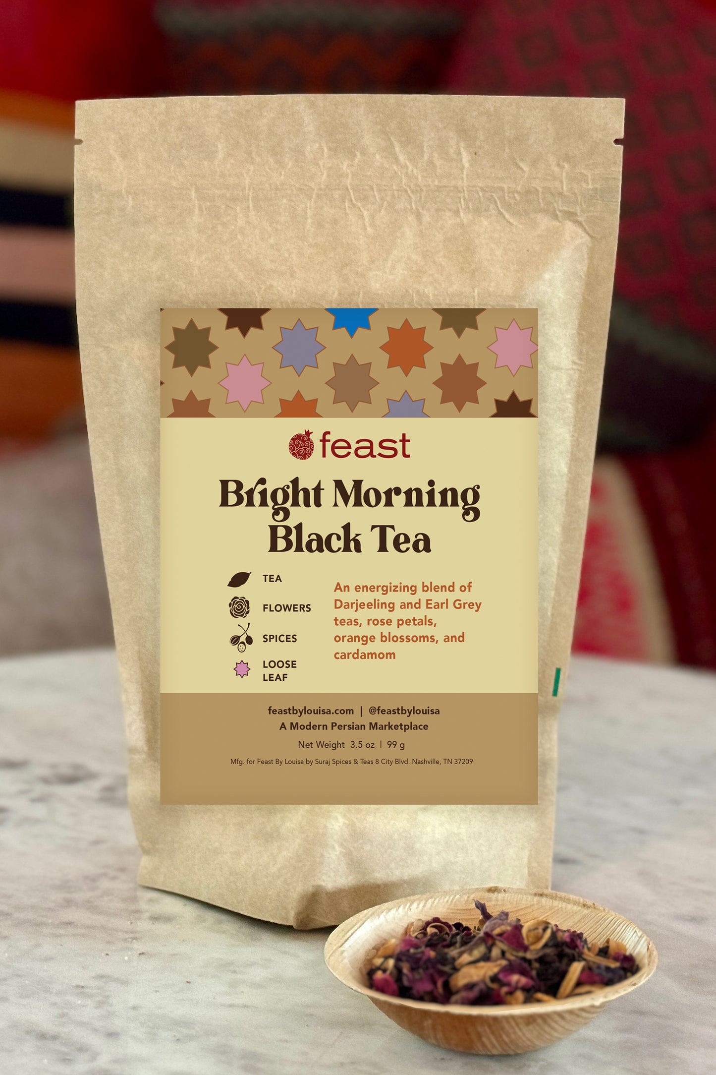 Bag of 'Bright Morning Black Tea' with a small bowl of tea leaves on a wooden surface.
